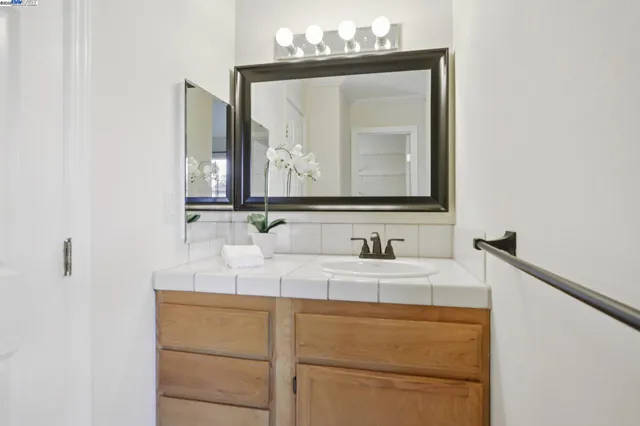 a bathroom with a sink vanity and a mirror