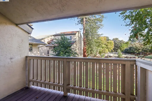a view of a balcony with wooden floor