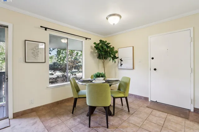 a view of a dining room with furniture and a potted plant