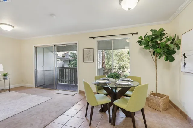 a view of a dining room with furniture and a potted plant