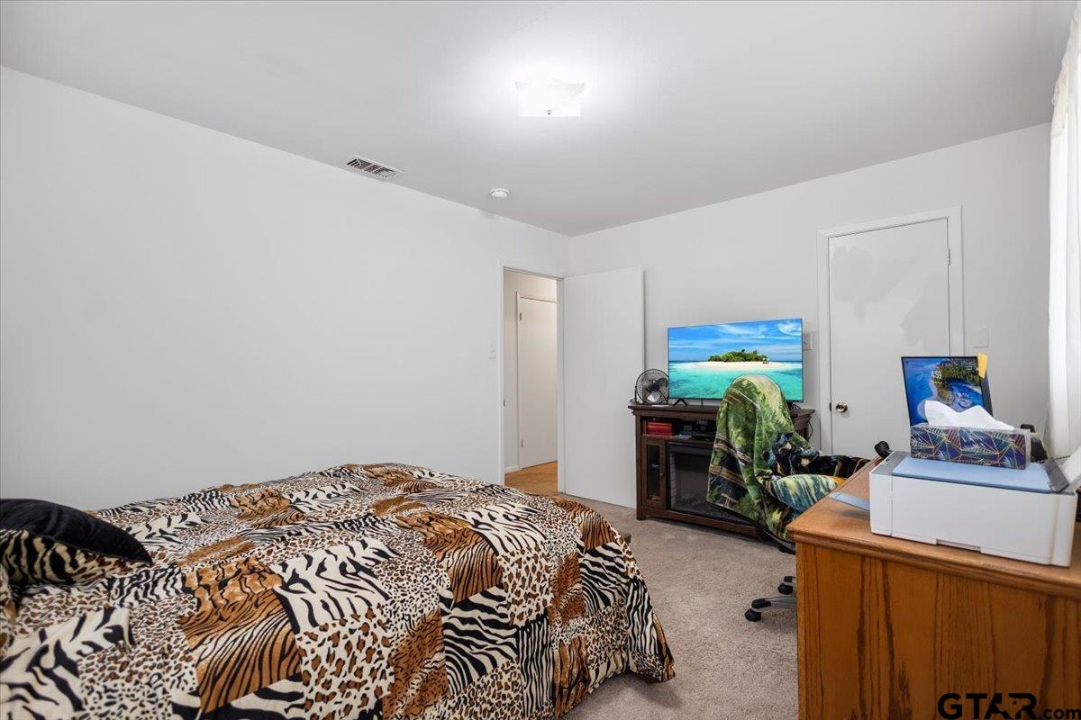 5357 Farm To Market Road 2087 Longview, TX 75603 - Photo 14 of 39 a bedroom with a bed and a lamp