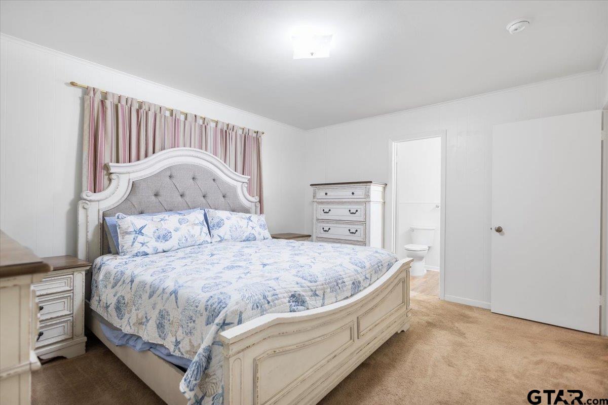 5357 Farm To Market Road 2087 Longview, TX 75603 - Photo 16 of 39 a bed sitting in a bedroom next to a window