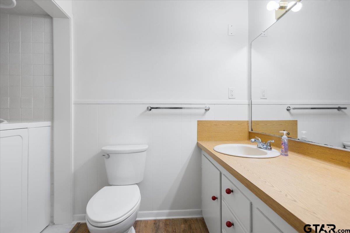 5357 Farm To Market Road 2087 Longview, TX 75603 - Photo 19 of 39 a bathroom with a sink a toilet and a mirror