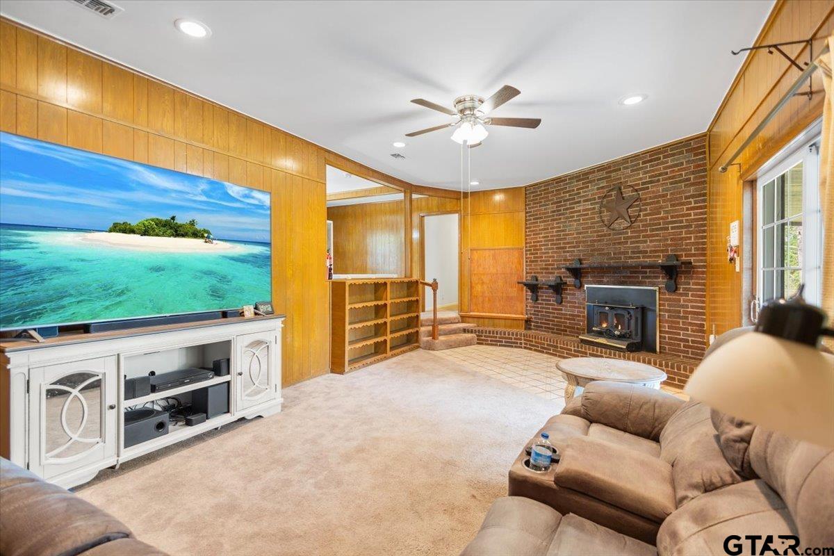 5357 Farm To Market Road 2087 Longview, TX 75603 - Photo 23 of 39 a living room with furniture a fireplace and a flat screen tv
