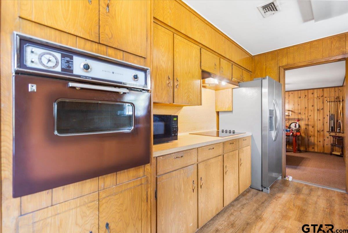 5357 Farm To Market Road 2087 Longview, TX 75603 - Photo 25 of 39 a kitchen with stainless steel appliances a stove a microwave and cabinets