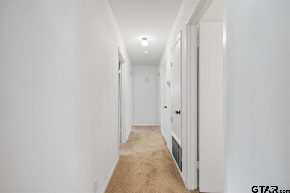 5357 Farm To Market Road 2087 Longview, TX 75603 - Photo 7 of 39 a view of a hallway with wooden floor