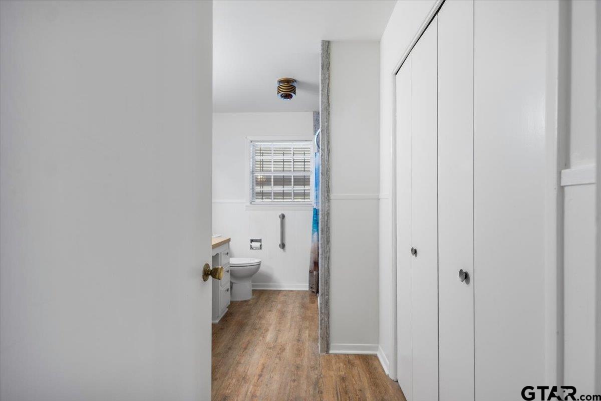 5357 Farm To Market Road 2087 Longview, TX 75603 - Photo 8 of 39 a view of a hallway with wooden floor and a bathroom
