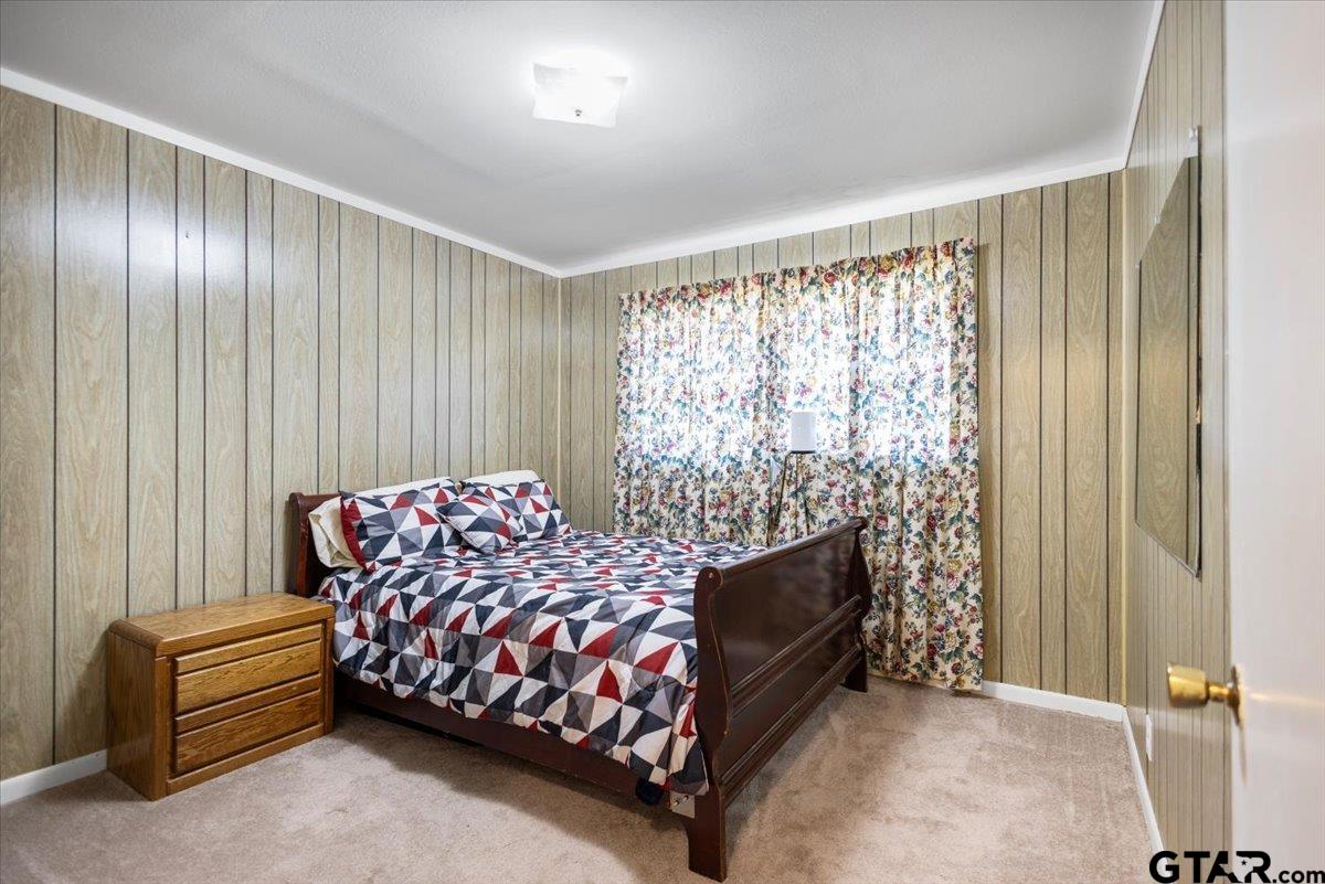 5357 Farm To Market Road 2087 Longview, TX 75603 - Photo 10 of 39 a bedroom with a bed and a chair