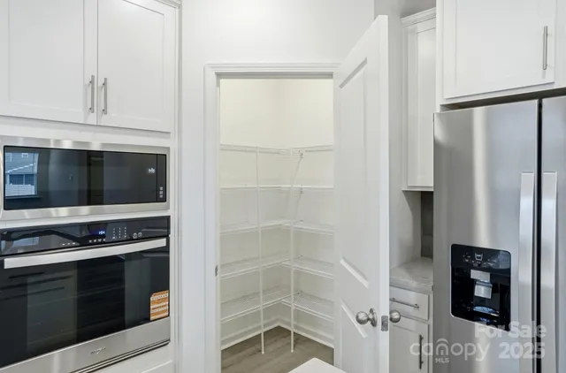 a kitchen with white cabinets and a stove