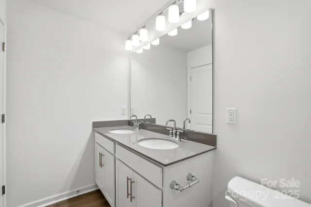 a bathroom with a sink vanity and a mirror