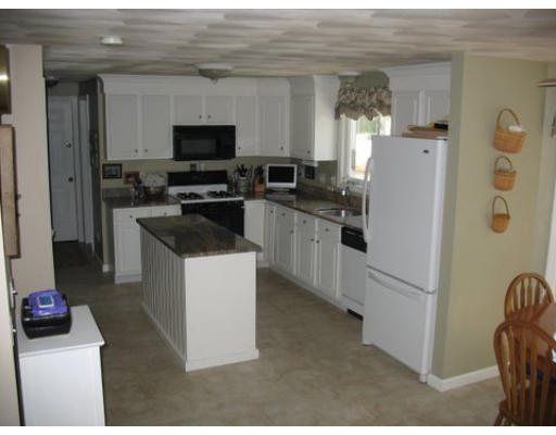 16 Country Hill Road Cumberland, RI 02864 - Photo 14 of 16 a kitchen with a refrigerator stove and microwave