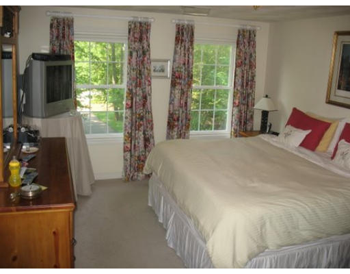 16 Country Hill Road Cumberland, RI 02864 - Photo 8 of 16 a bedroom with a bed window and potted plant
