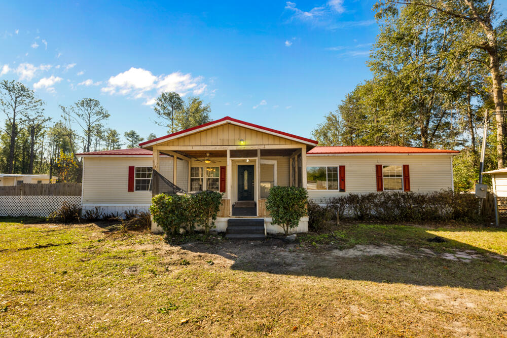 5710 US 90 Lee, FL 32059 - Photo 1 of 38 a front view of a house with garden