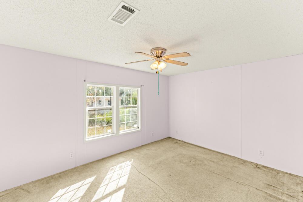5710 US 90 Lee, FL 32059 - Photo 19 of 38 an empty room with a window and a fan