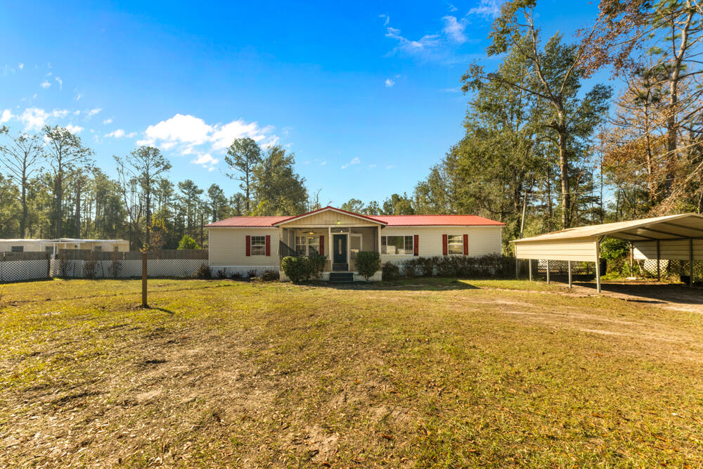5710 US 90 Lee, FL 32059 - Photo 2 of 38 a front view of a house with a yard