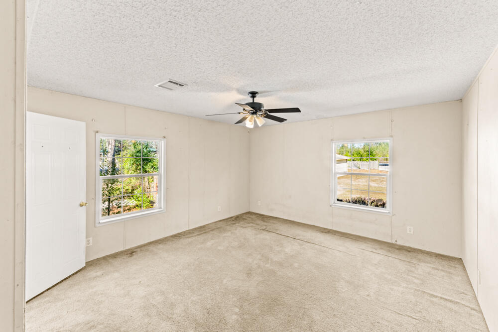 5710 US 90 Lee, FL 32059 - Photo 26 of 38 an empty room with windows and fan view