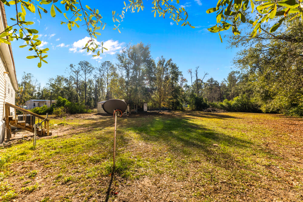5710 US 90 Lee, FL 32059 - Photo 34 of 38 a blue swimming pool with a yard