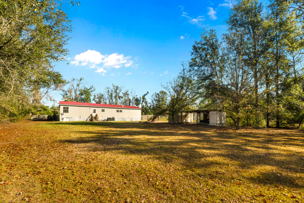 5710 US 90 Lee, FL 32059 - Photo 37 of 38 a multi story building with trees in front of it