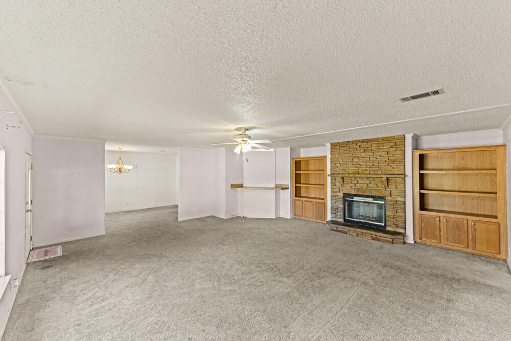 5710 US 90 Lee, FL 32059 - Photo 7 of 38 an empty room with fireplace cabinet and windows