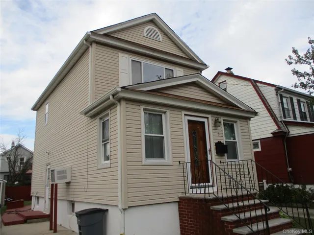 a view of a house with wooden fence