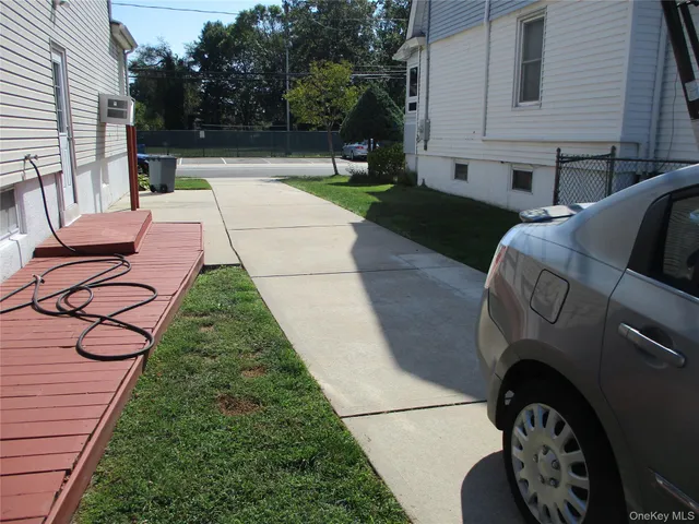 a view of backyard with outdoor seating and green space