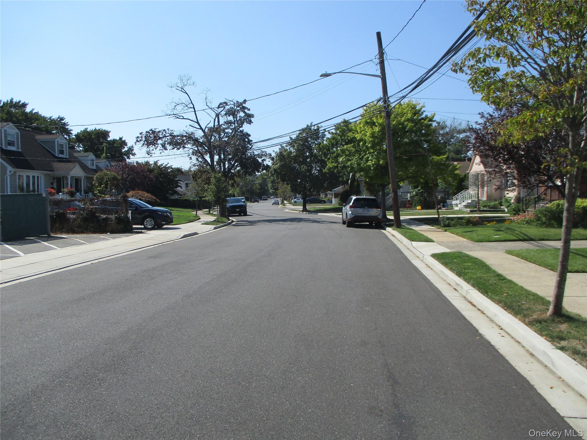 6 Birch Lane Valley Stream, NY 11581 - Photo 2 of 15 a view of a road with a car parked on the road