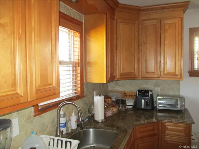 a kitchen with a window a sink and a cabinets