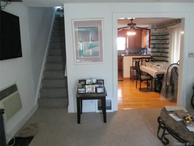 a view of a livingroom with furniture and staircase