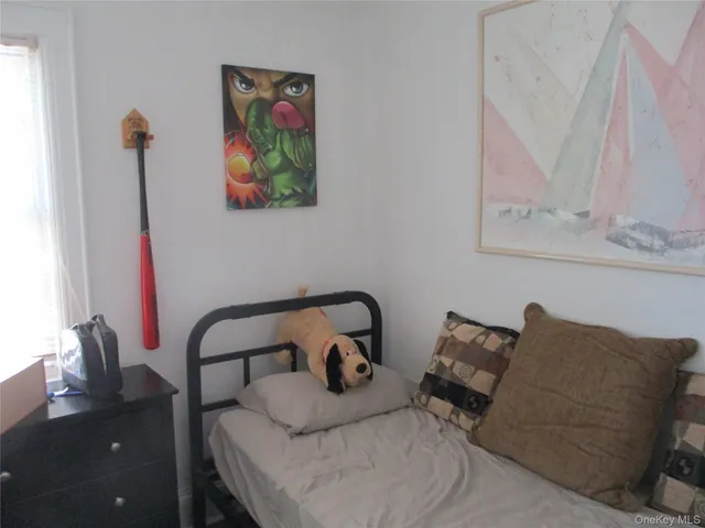 a bedroom with furniture and a window