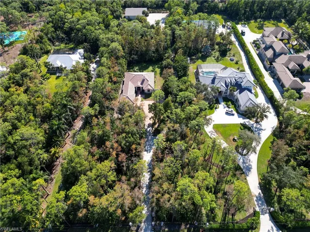 an aerial view of residential house with outdoor space and swimming pool