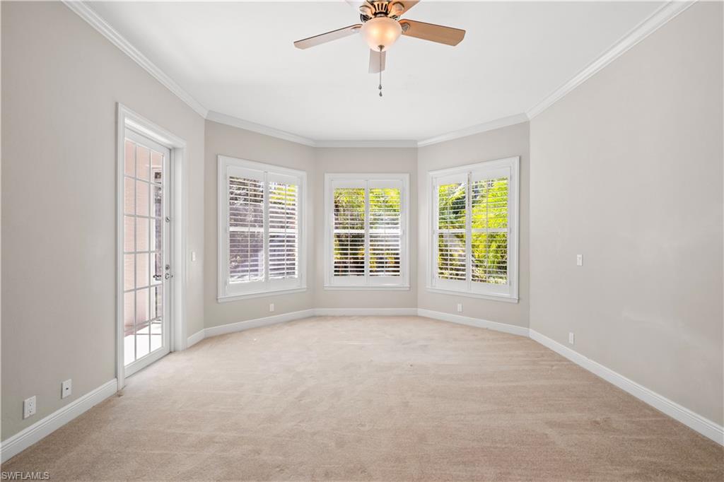 6800 Hunters Road Naples, FL 34109 - Photo 6 of 16 Unfurnished room with crown molding, light colored carpet, and a ceiling fan