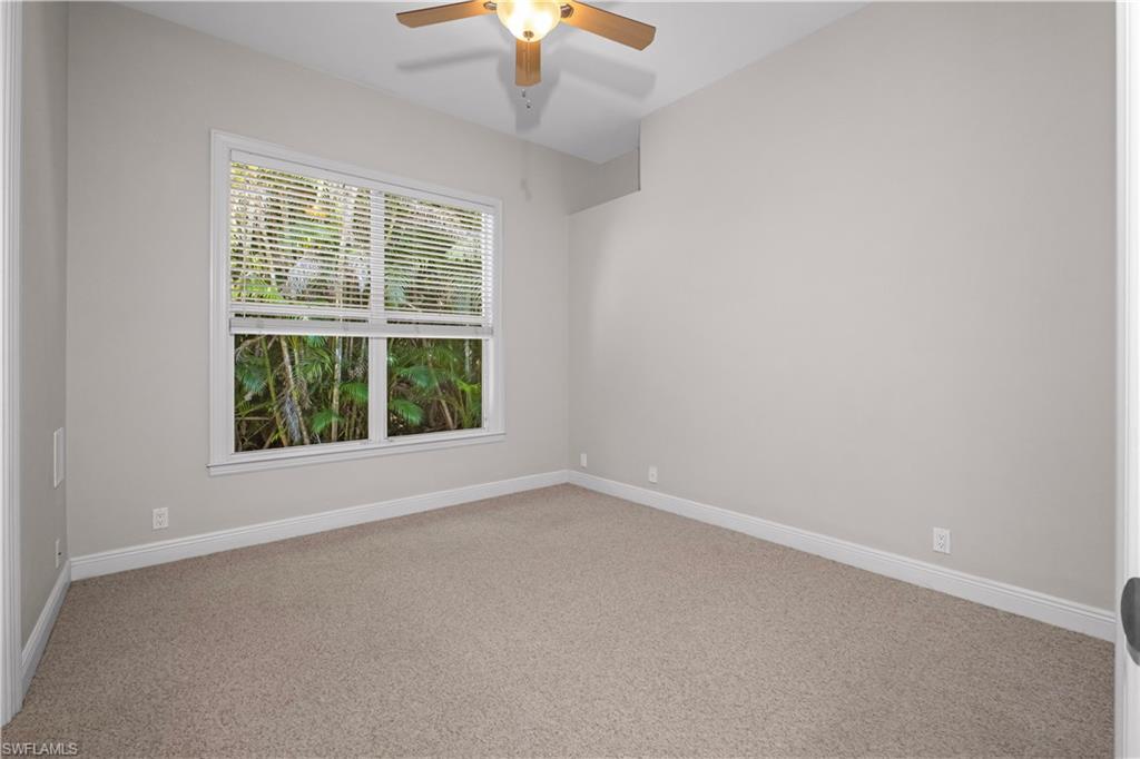 6800 Hunters Road Naples, FL 34109 - Photo 7 of 16 Empty room with light carpet and a ceiling fan