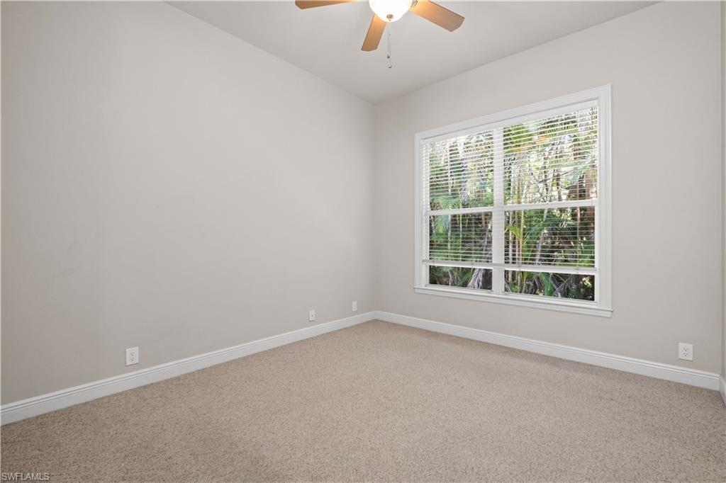 6800 Hunters Road Naples, FL 34109 - Photo 8 of 16 Carpeted empty room featuring baseboards and ceiling fan