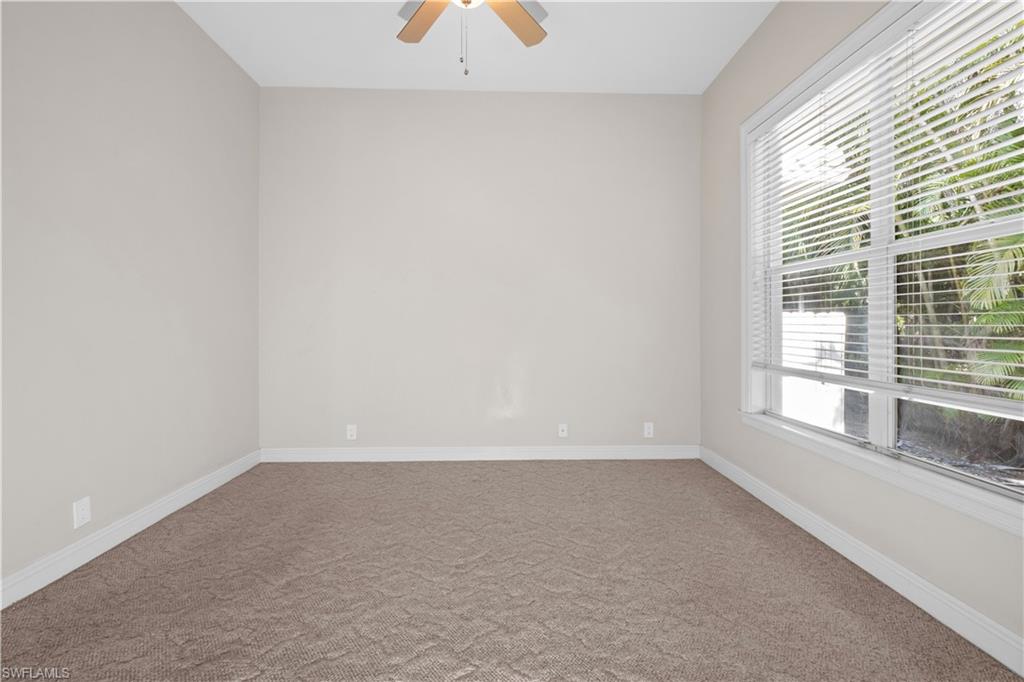 6800 Hunters Road Naples, FL 34109 - Photo 9 of 16 Carpeted empty room featuring baseboards and a ceiling fan