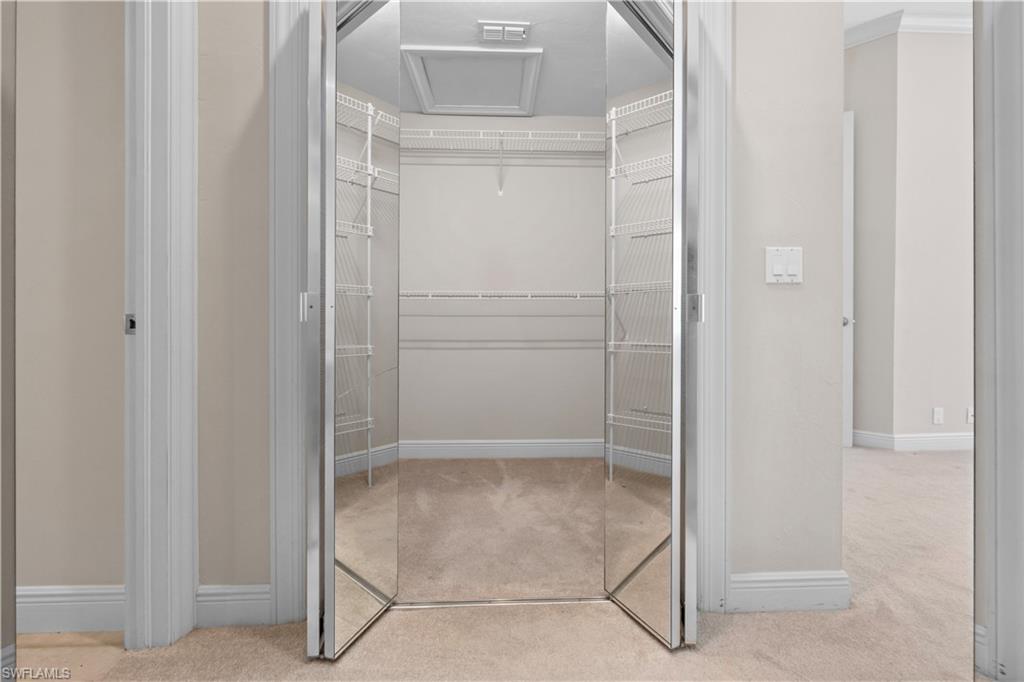 6800 Hunters Road Naples, FL 34109 - Photo 10 of 16 Walk in closet featuring light carpet and attic access