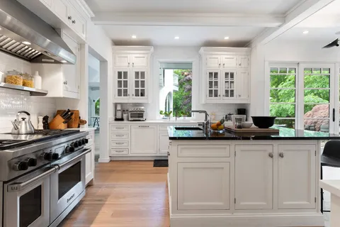 a kitchen with stainless steel appliances granite countertop a stove and a sink