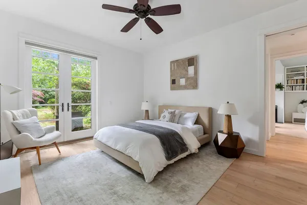 a bedroom with a bed a couch and a window