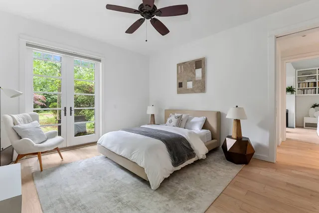 a bedroom with a bed a couch and a window