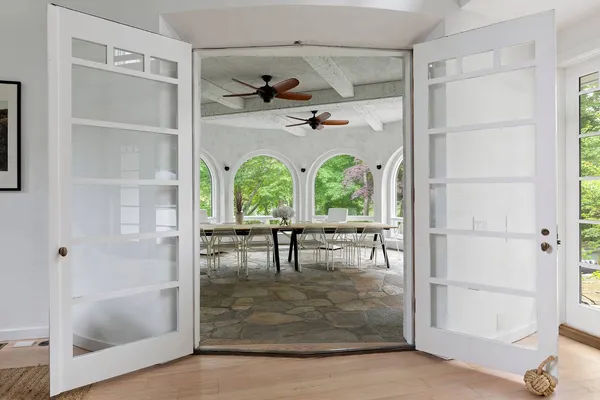 a view of a hallway with wooden floor and a window
