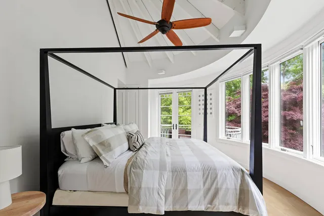 a bed sitting in a bedroom next to a window