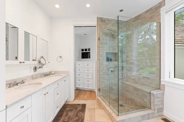 a bathroom with a shower sink and mirror