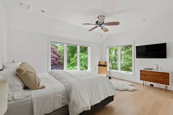 a bedroom with a bed and flat screen tv