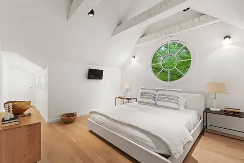 a bedroom with a bed and a mirror