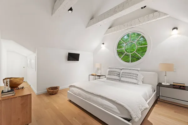 a bedroom with a bed and a mirror