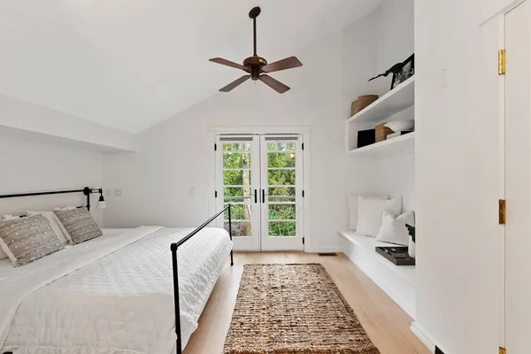 a bedroom with a large bed and a window