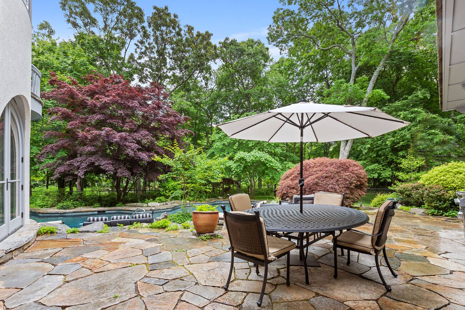 112 Georgica Close Road East Hampton, NY 11937 - Photo 37 of 46 a patio with a patio table and chairs