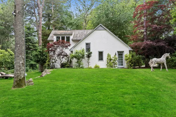 a view of a house with a yard and garden