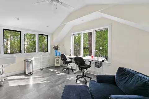a living room with furniture and large windows