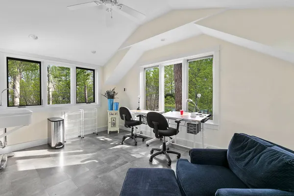 a living room with furniture and large windows