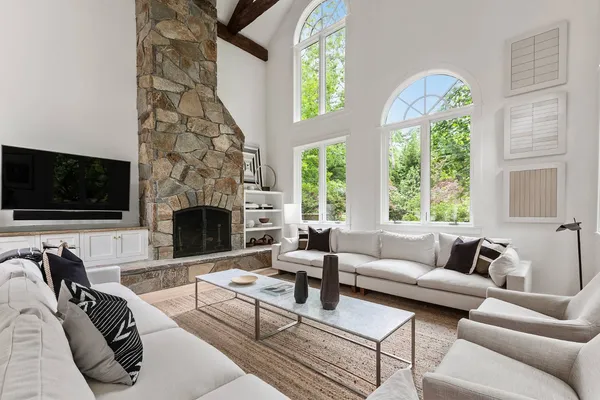 a living room with furniture a flat screen tv and a fireplace